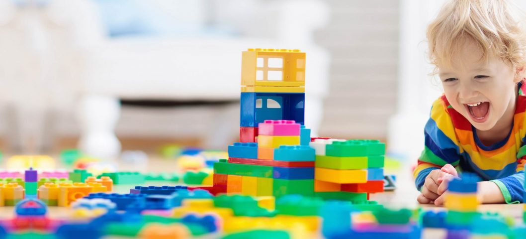 Little boy playing with legos.