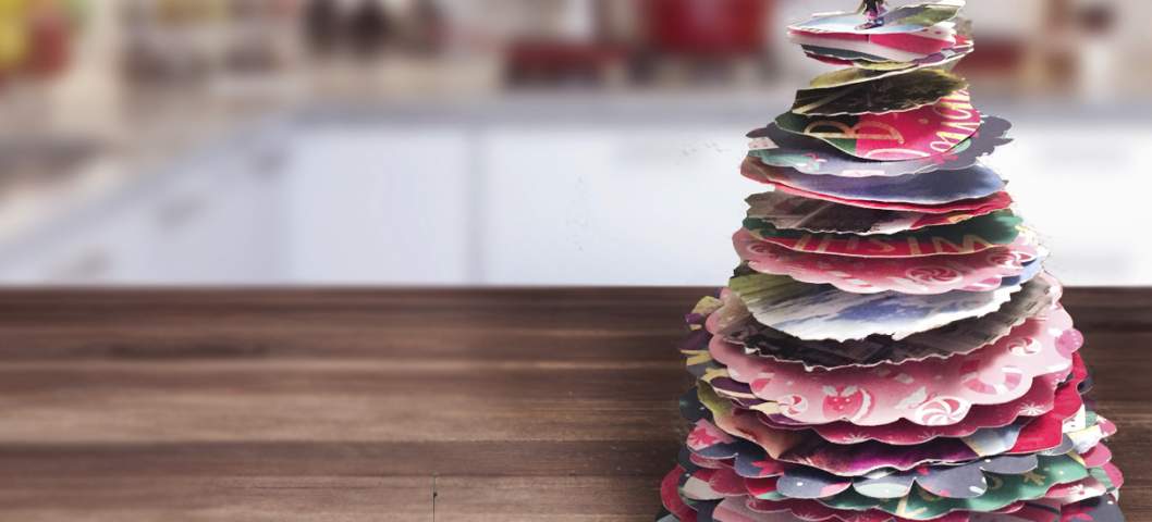 Empty rustic wood kitchen counter-top with blurred modern kitchen at background with christmas card upcycle for how to recycle greeting cards