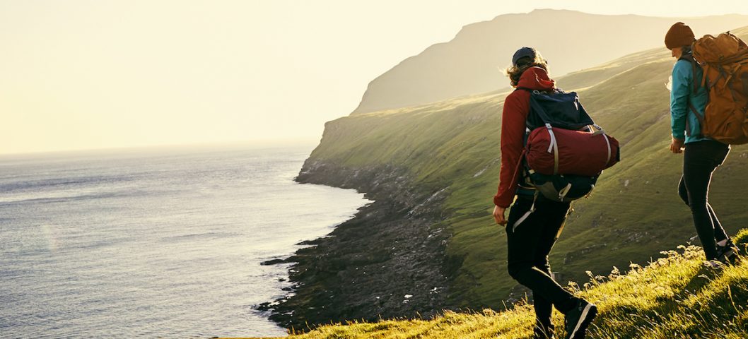 Two hikers reach the coastline