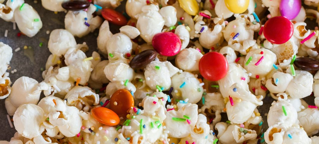 Delicious Sweet Popcorn With Colorful Candies And Sprinkles.