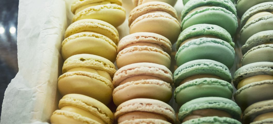 Mixed color of French macaroons in box.