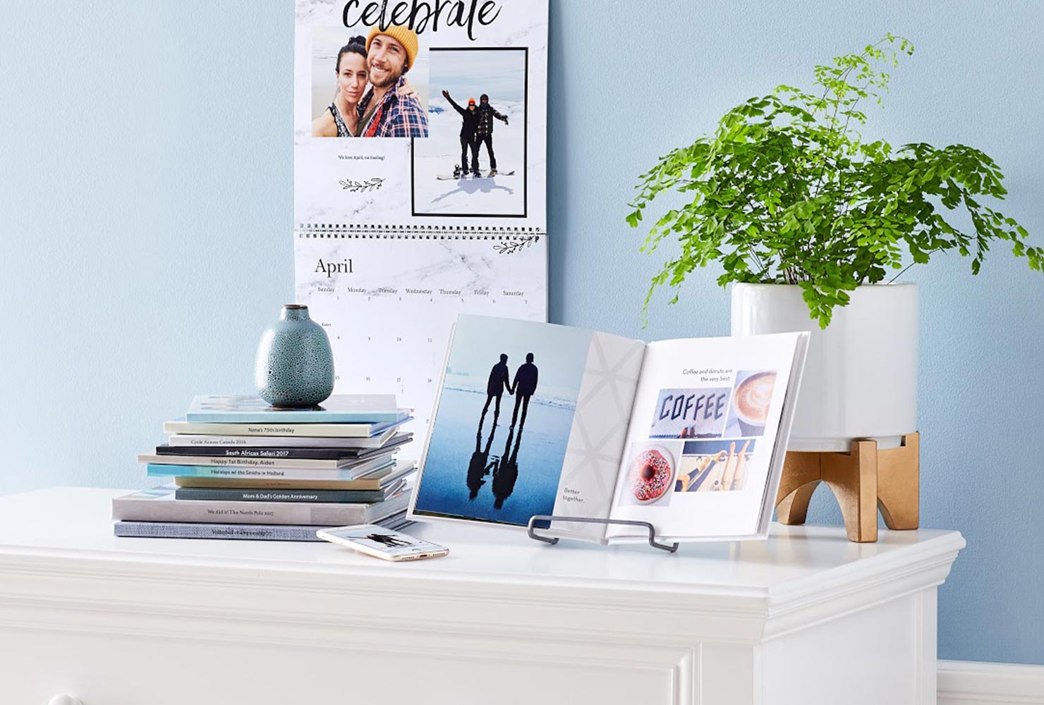 photo book displayed on shelf with hardcover and collage layout