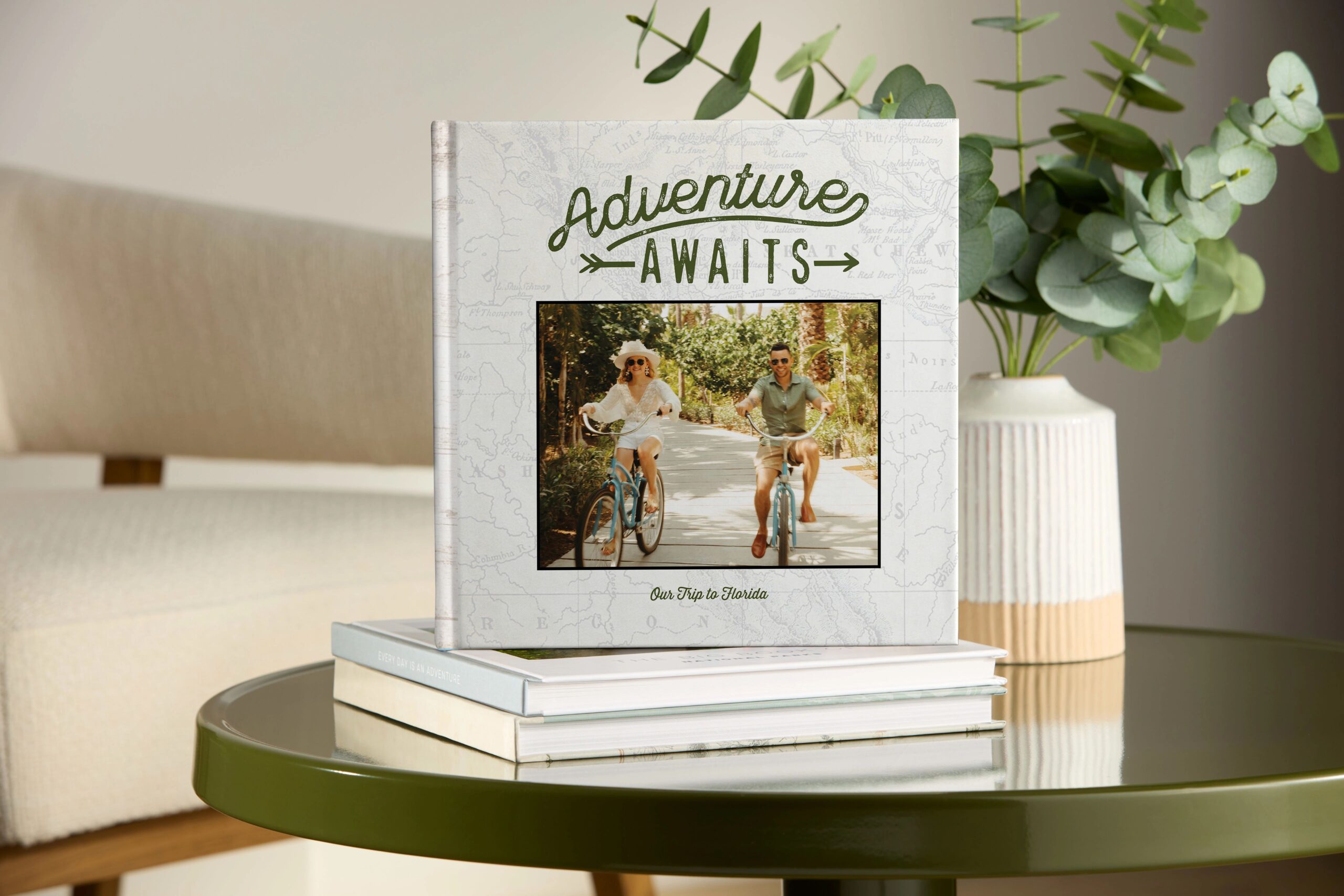 photo book with cover featuring couple on bikes that says adventure awaits