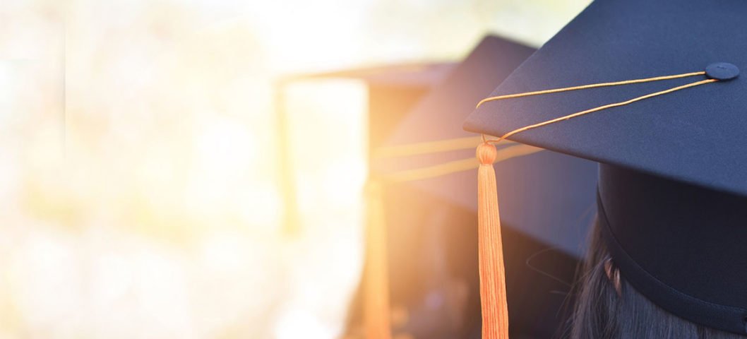 Blue graduation caps lined up for graduation ceremony