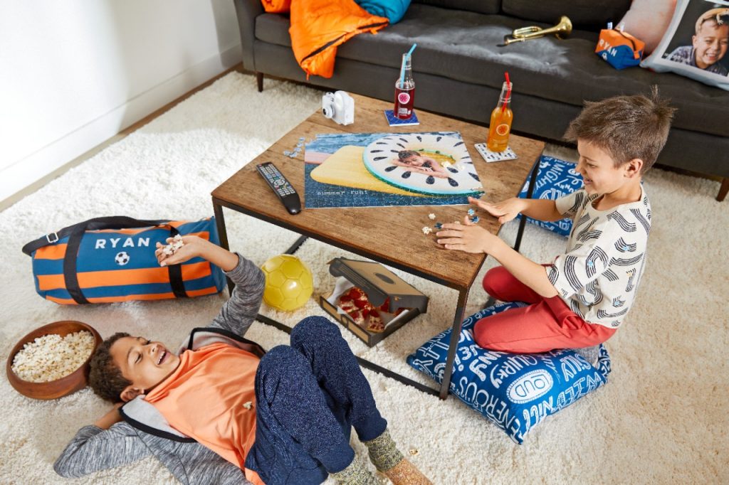 two kids solving a jigsaw puzzle together
