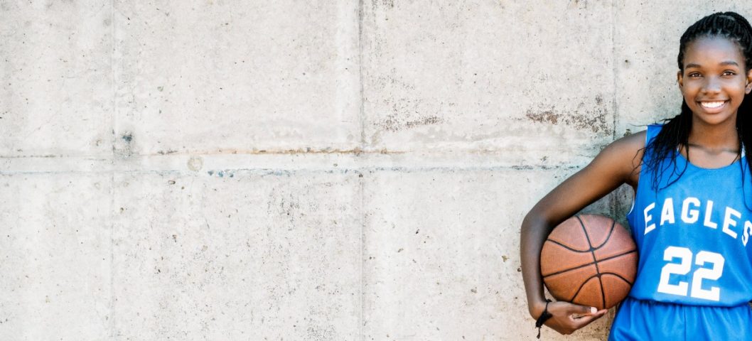 female basketball uniform against a wall