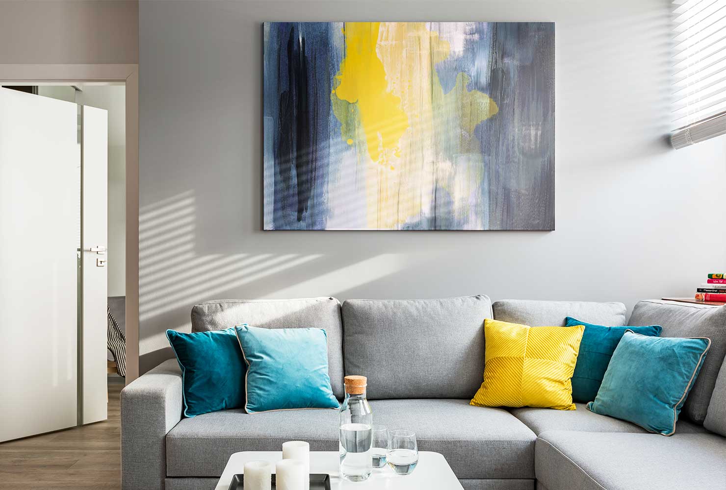 Abstract canvas hanging above couch.