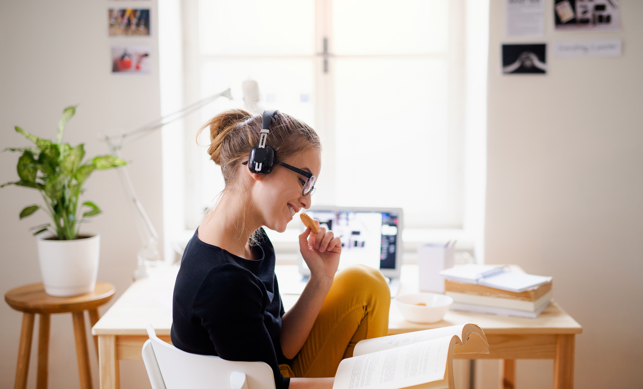 young student eating a snack while studying