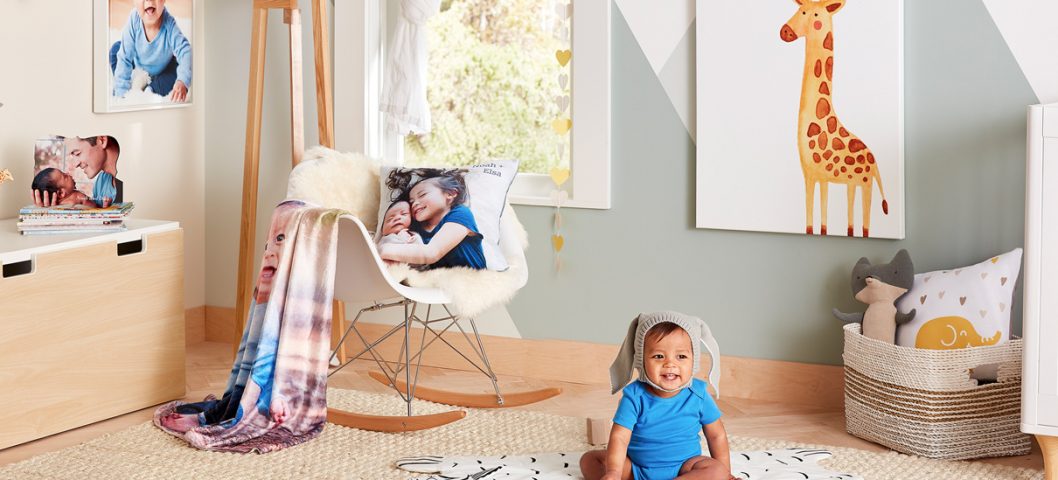 Baby sitting on floor in nursery.