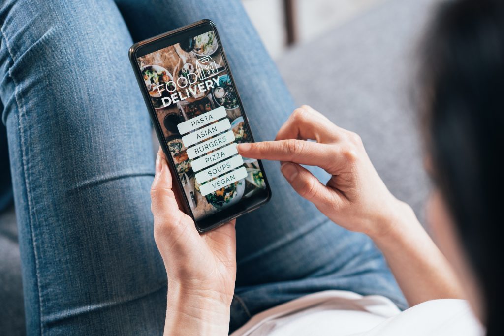 Woman ordering food online on her electronic device
