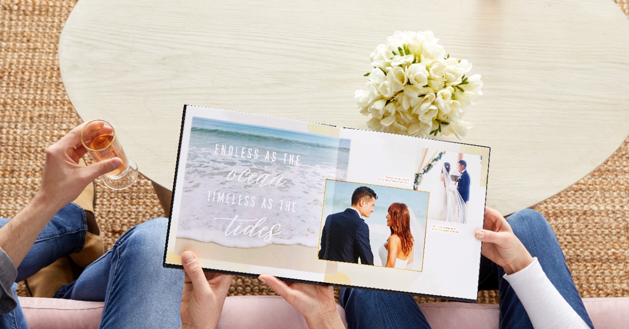 couple flipping through a wedding photo book