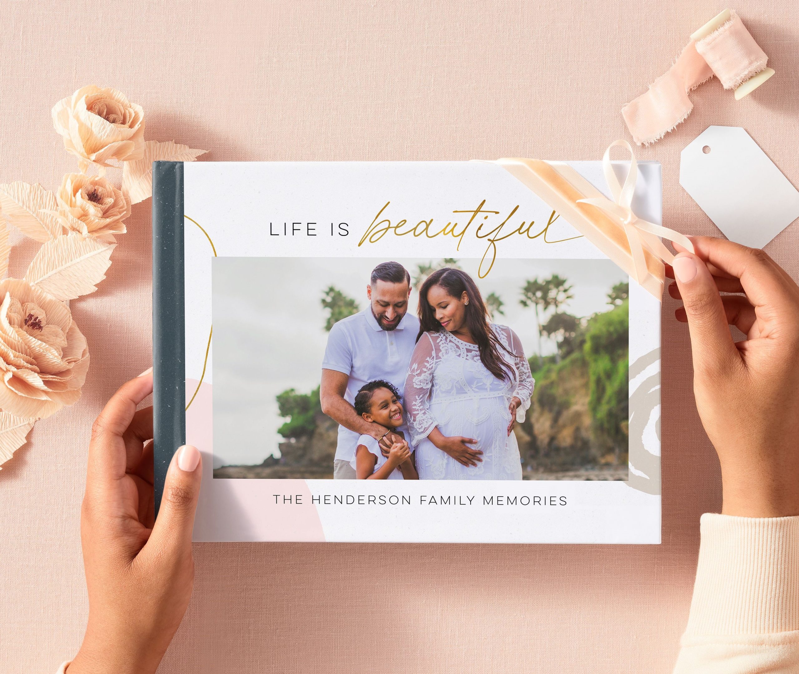 the cover of a family photo book with a family of three displayed