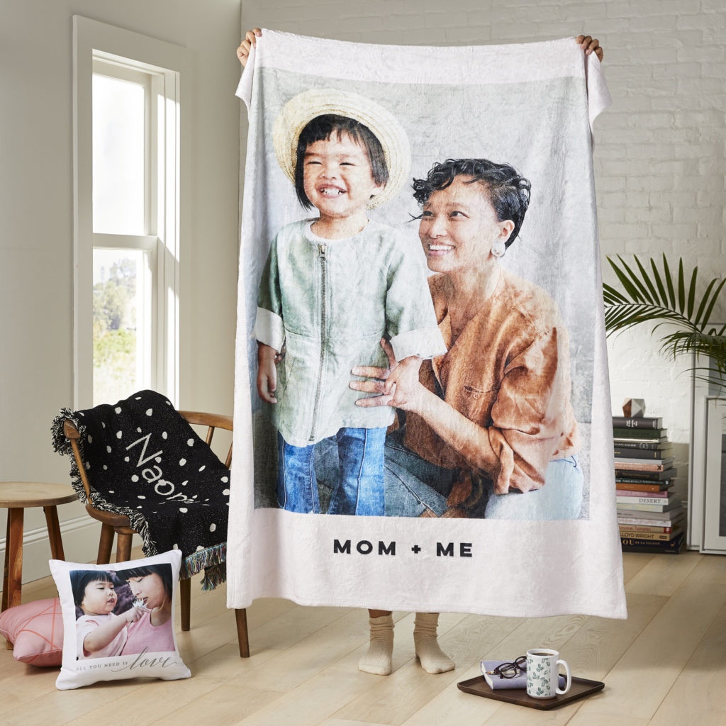 mom holding up blanket