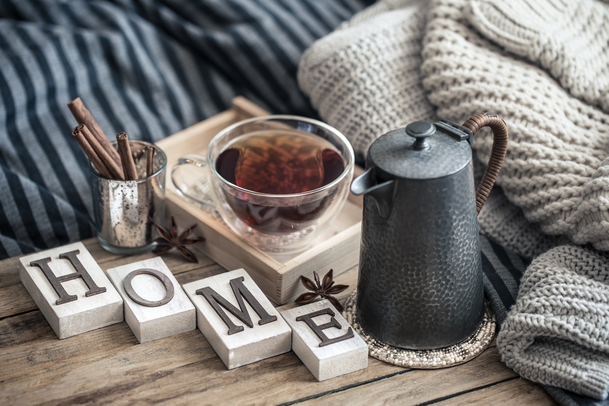 home decorations in the interior of a letter with an inscription home on a wooden background in the interior of the bedroom