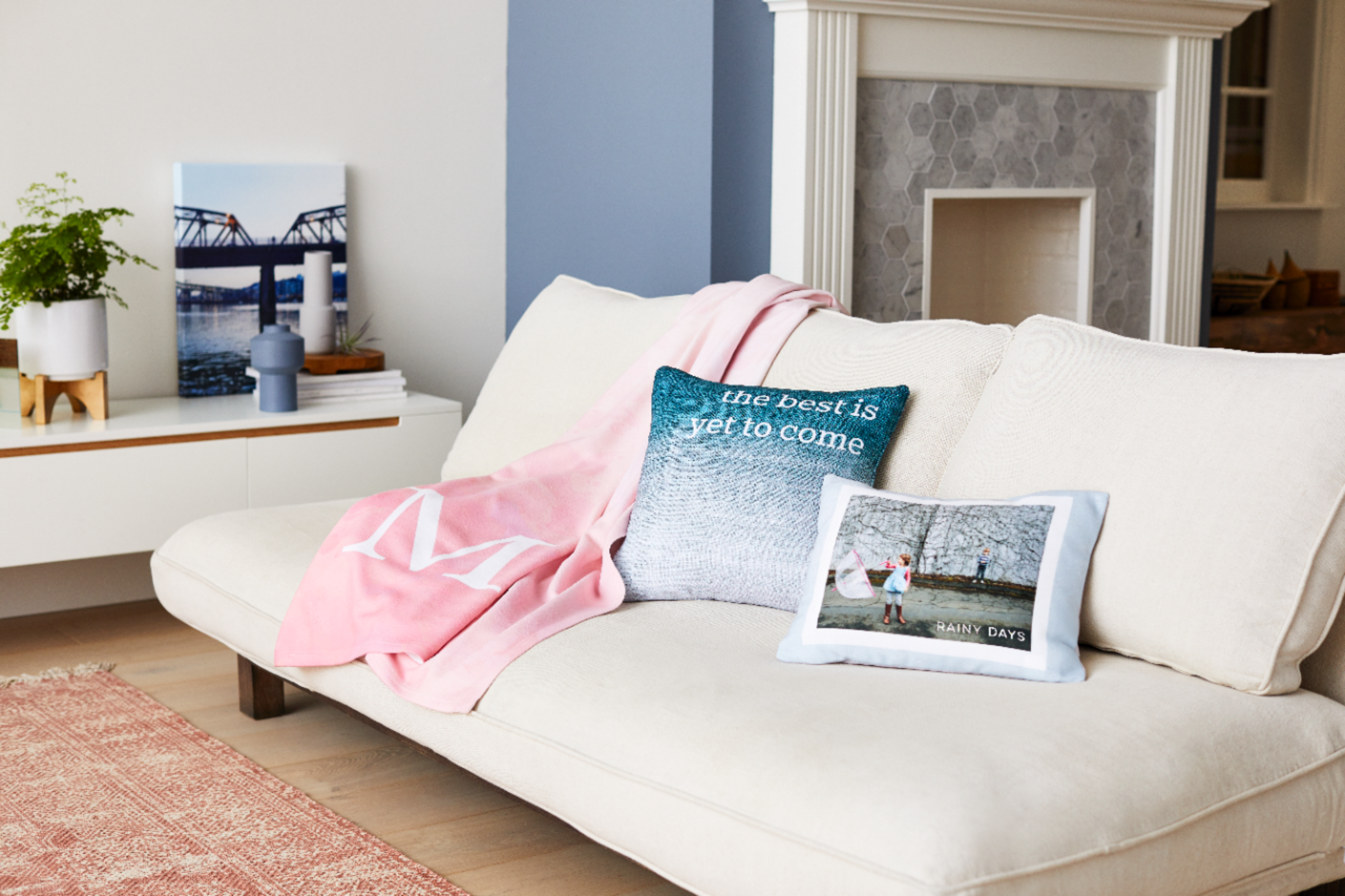Personalized fleece blanket with custom photo pillows on a couch