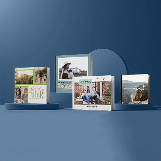 Photo books in different styles and formats on a blue background