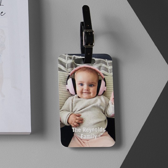 Personalized luggage tags with a photo of a baby for a baby shower gift