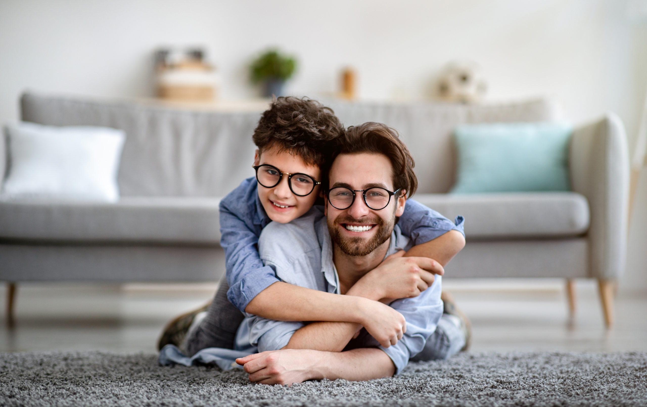 Dad and son cuddling together on Father's Day