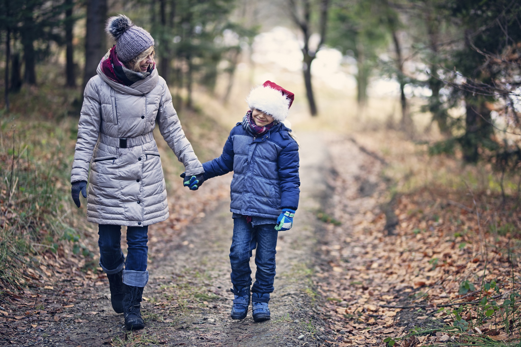 Mother and son enjoying walk in forest.