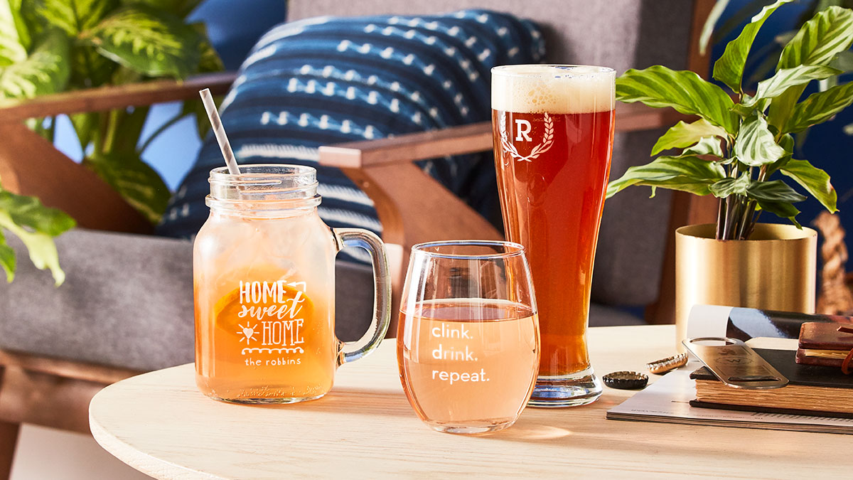 Wedding gift ideas featuring personalized wine glasses, Pilsner glasses, and mason jar mugs