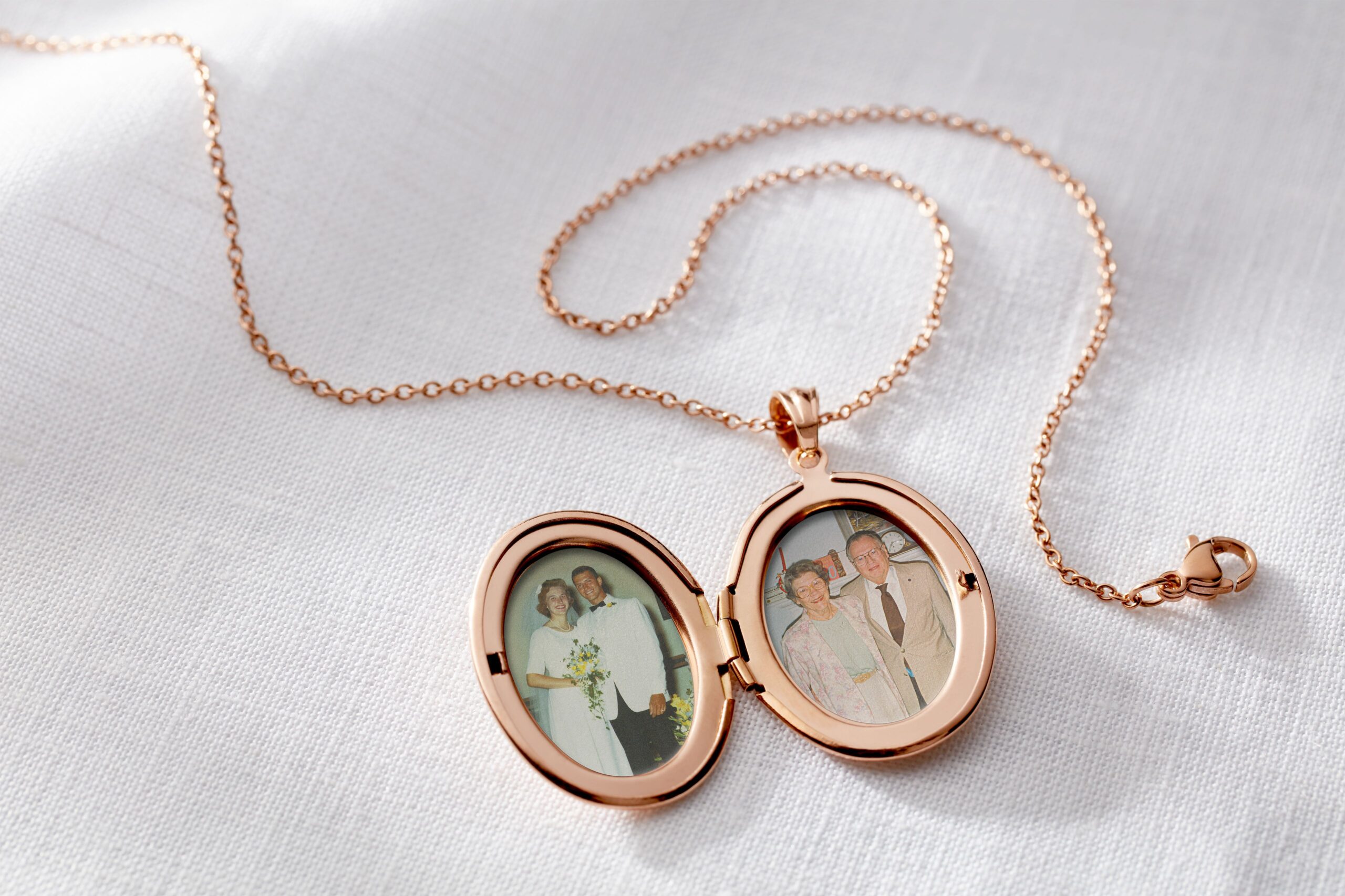 gold locket necklace with pictures of an elderly couple inside