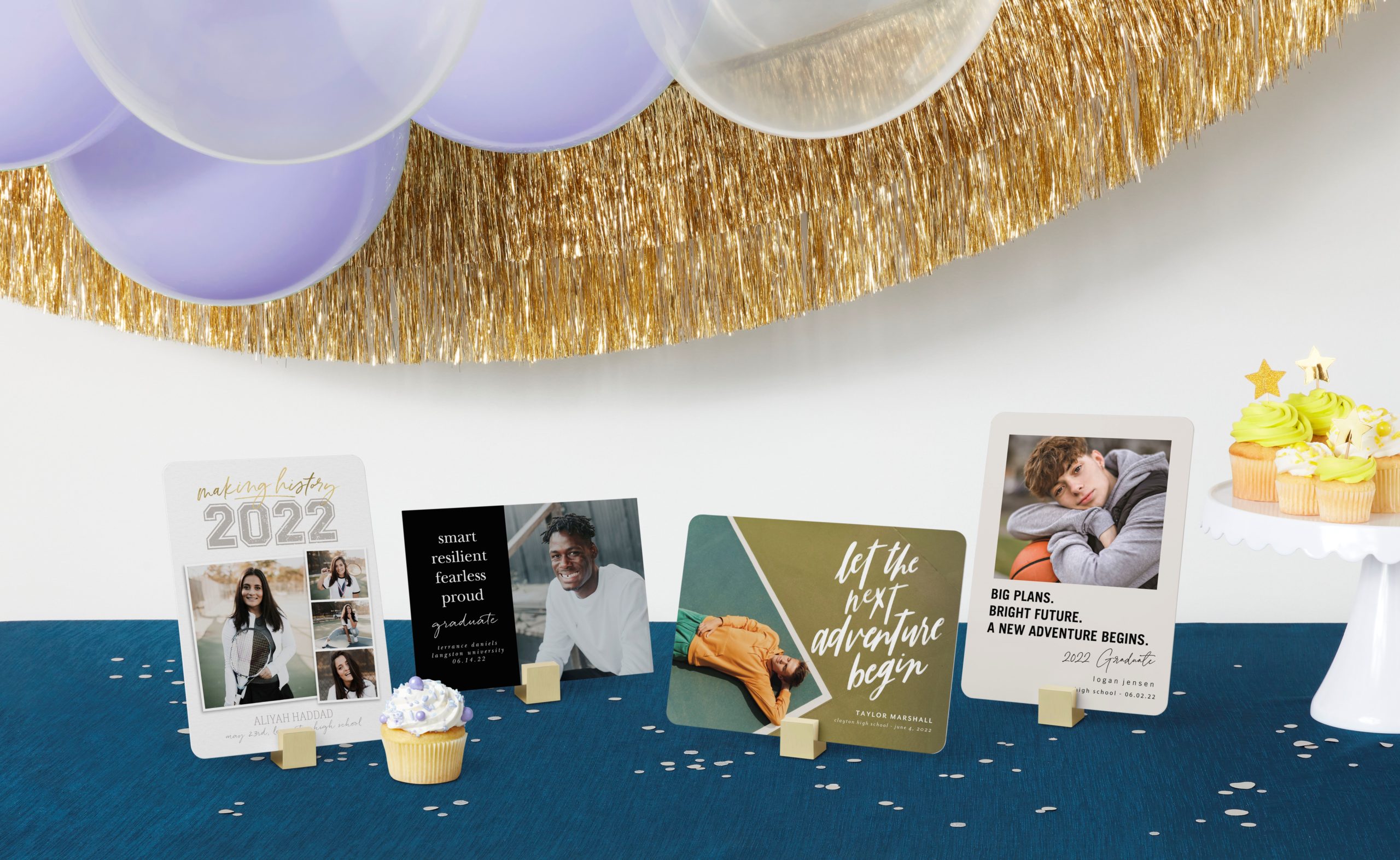 Class of 2022 display of cards with party decorations and cupcakes on a blue table