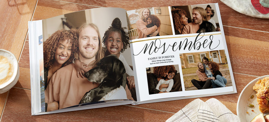 Custom photo book featuring family snapshots displayed alongside a tea towel and ceramic mug