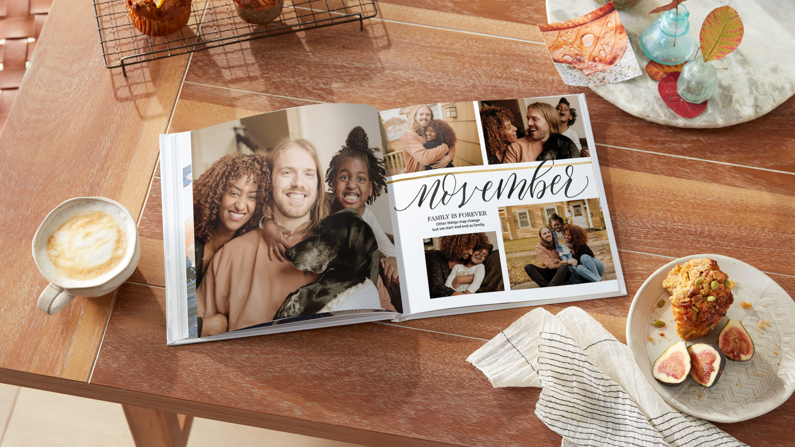 Featured image of a custom photo book showcasing family snapshots displayed alongside a tea towel and ceramic mug
