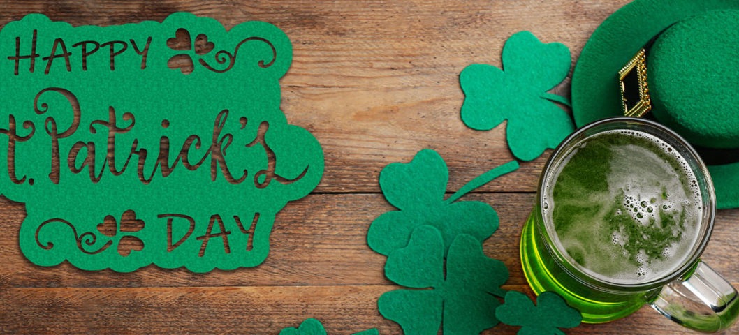 happy st patricks day hero image with wood background and green decorations