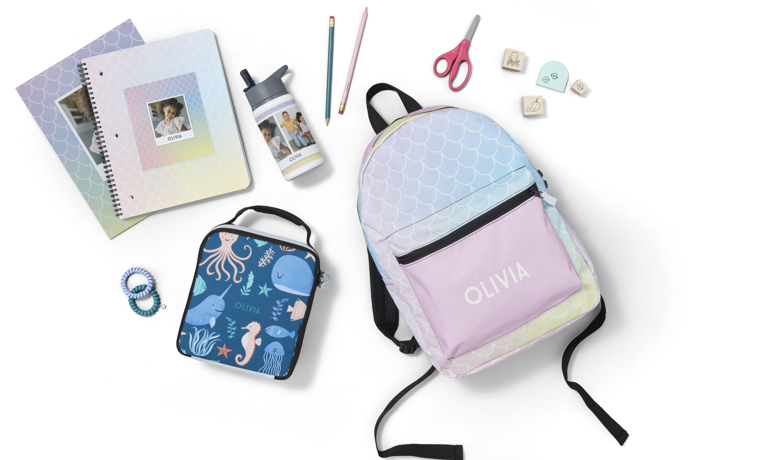 Personalized pastel colored backpack lunchbag folder and notebook featuring various school supplies