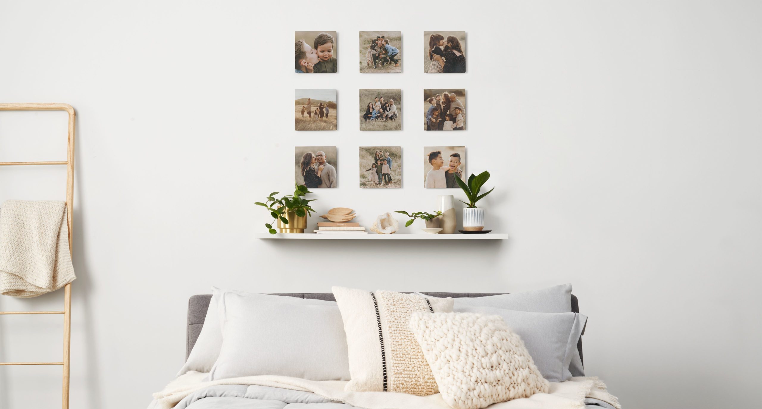 Nine photo tiles above a bed in a bedroom