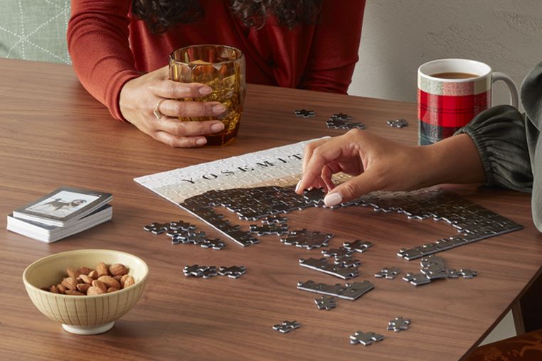 People putting together a custom jigsaw puzzle