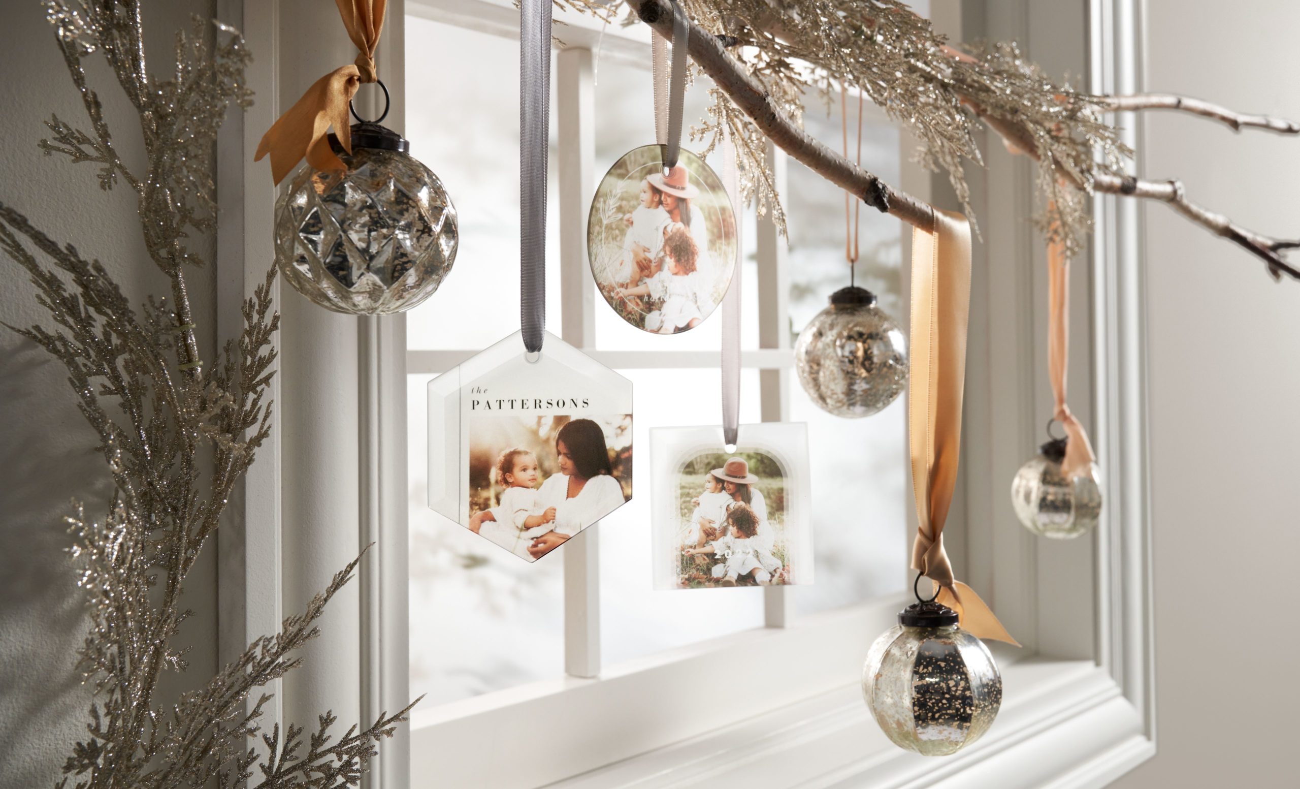 Selection of personalized Christmas ornaments with photos hanging