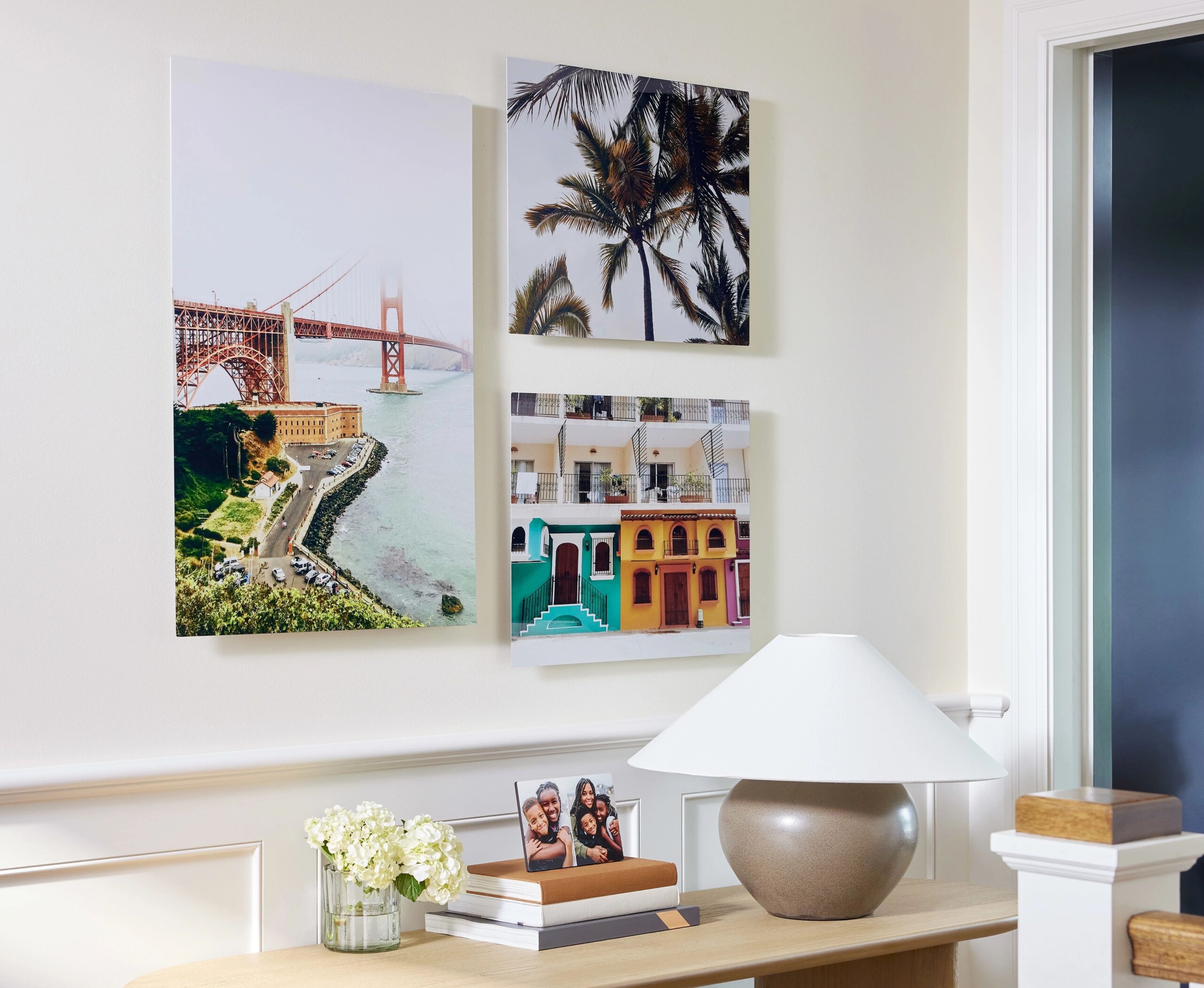 three metal prints hanging on a wall