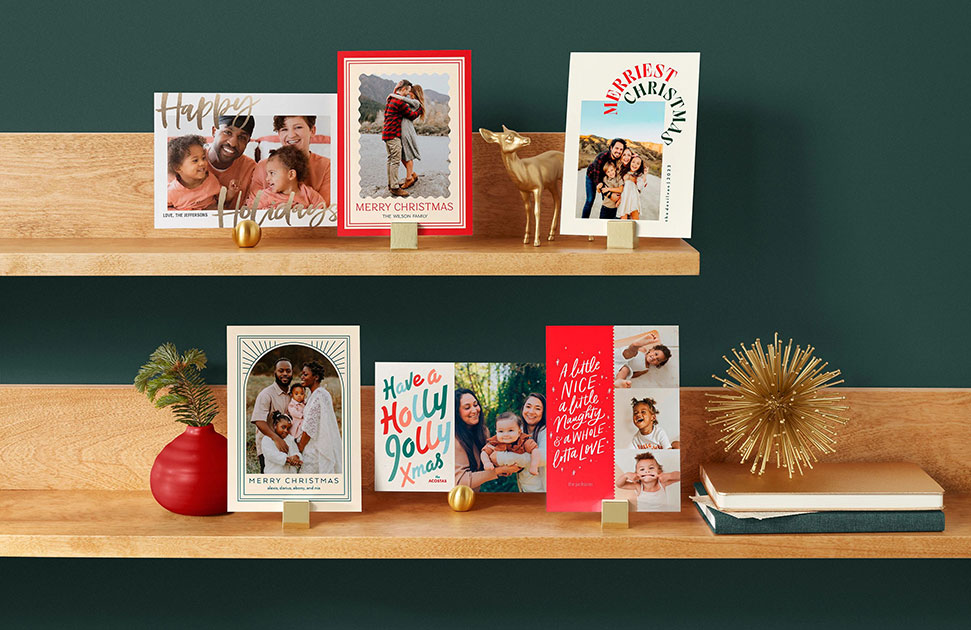 Six photo Christmas cards displayed on shelves with other festive holiday decor