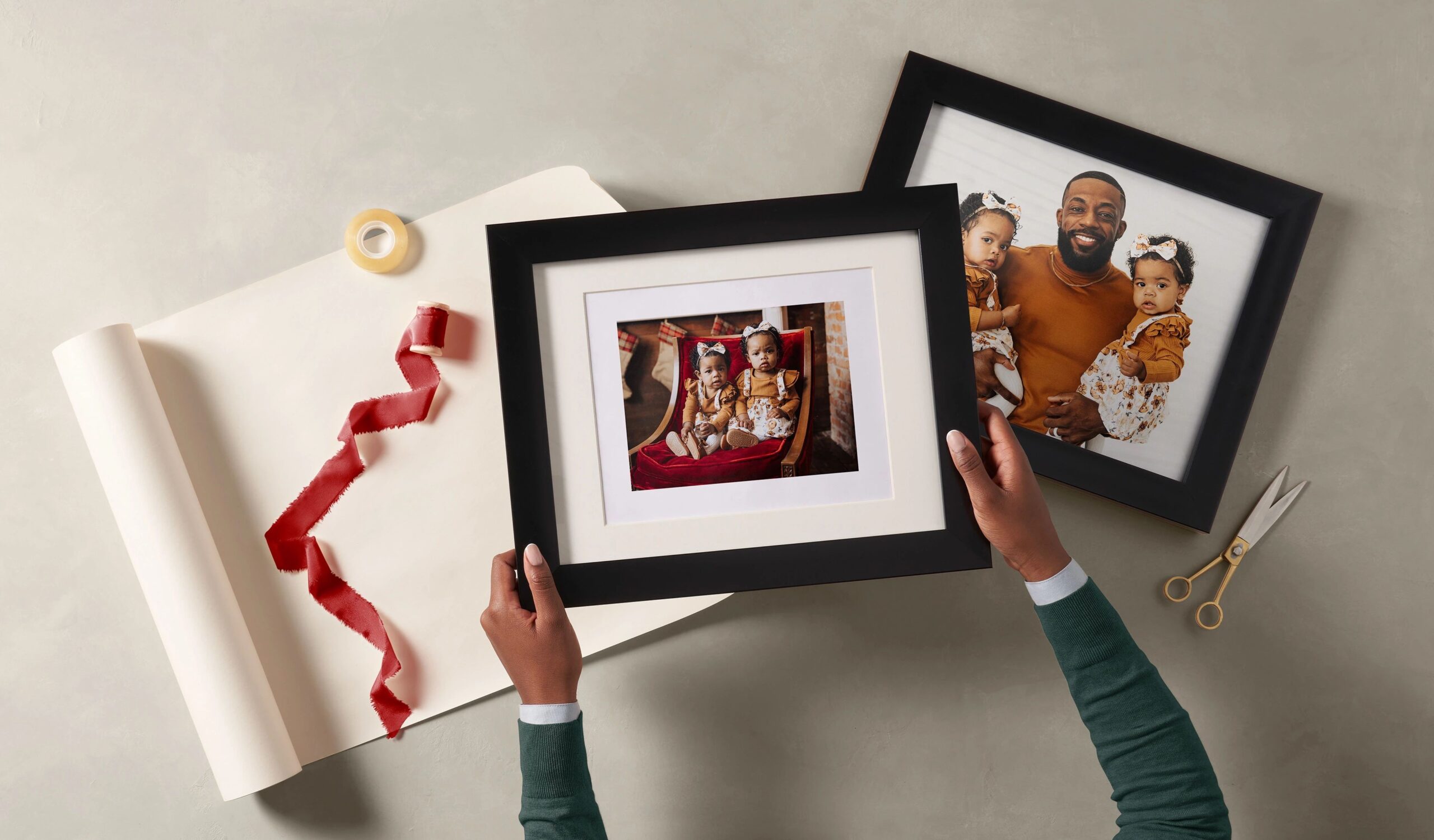 wrapping two custom framed prints with pictures of a family