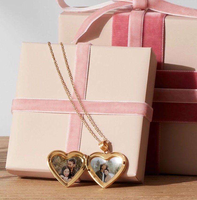 open photo locket in front of a gift box