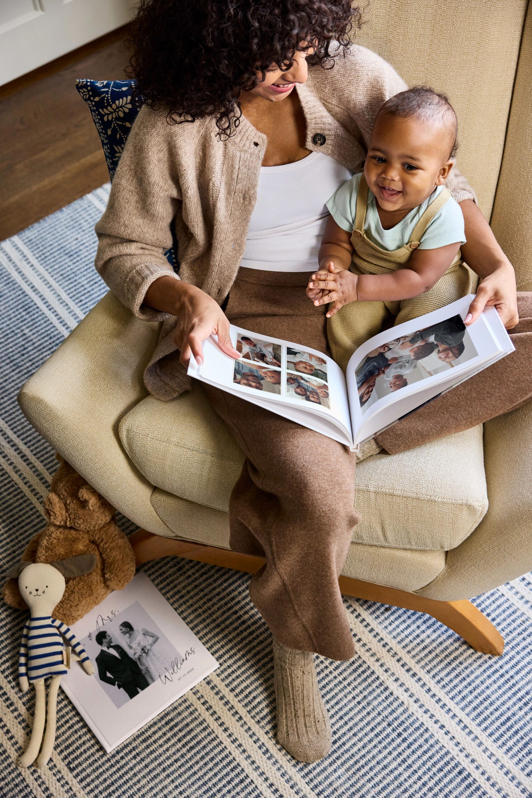 mother and baby flipping through a photo book
