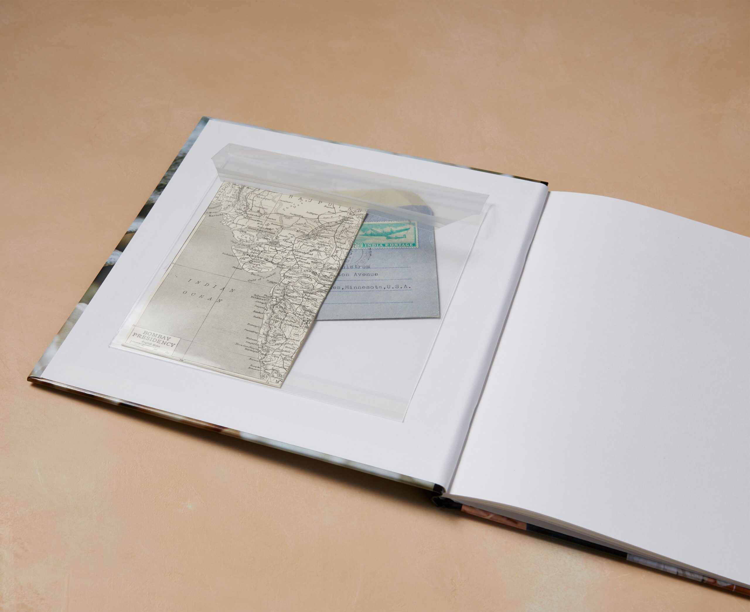 open photo book with a memorabilia pocket with a map inside