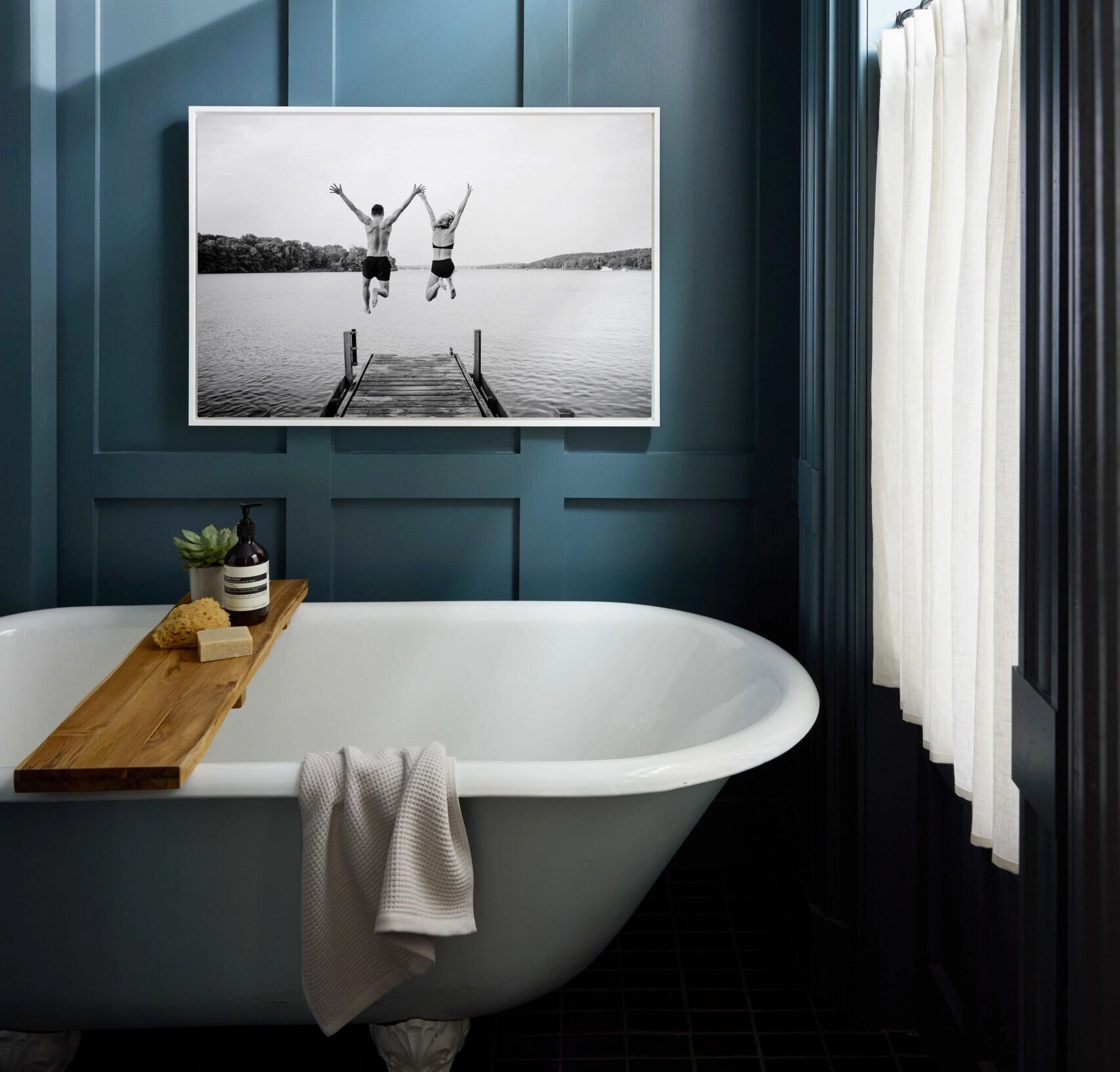 metal print in bathroom above bathtub