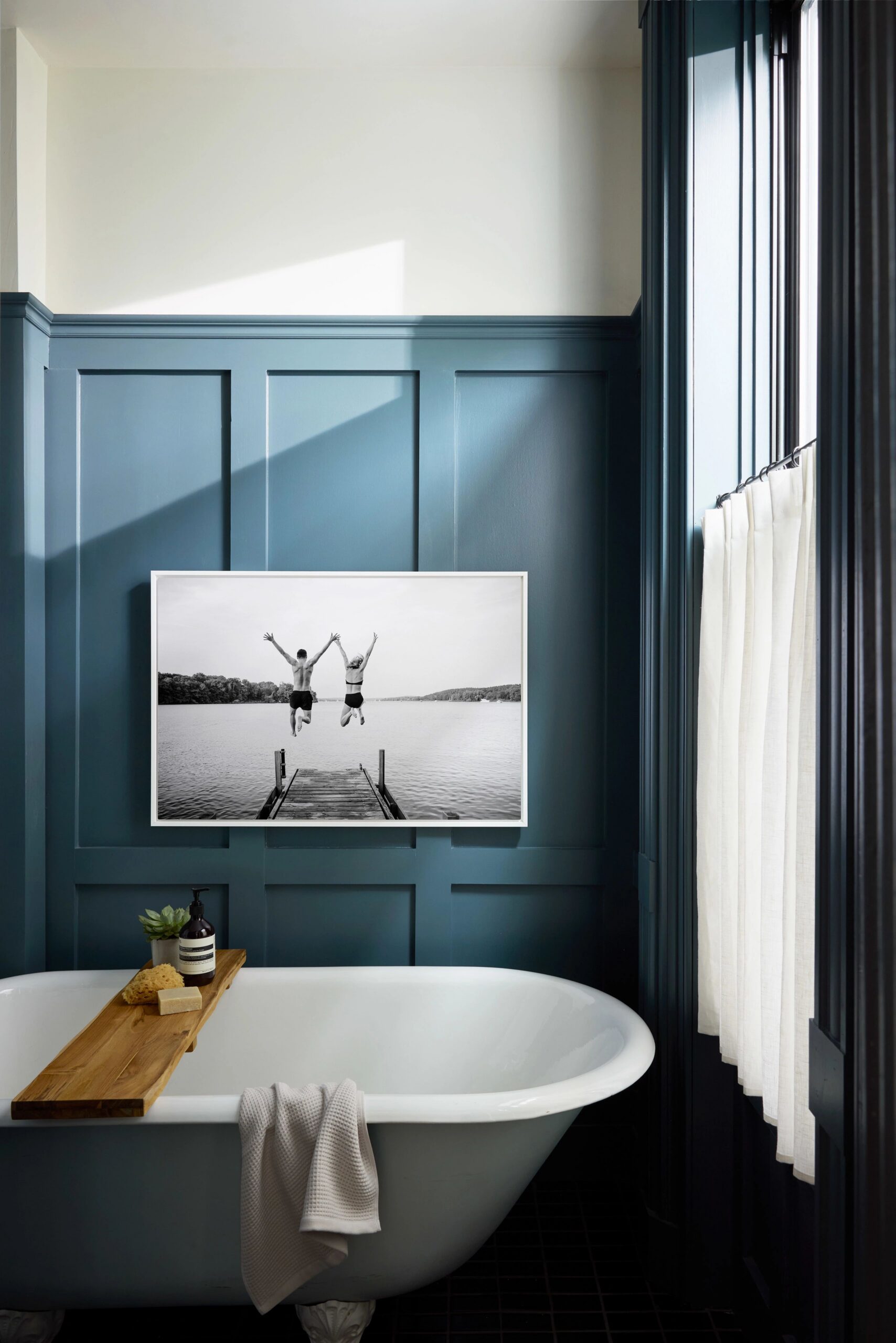 metal print in bathroom above bathtub