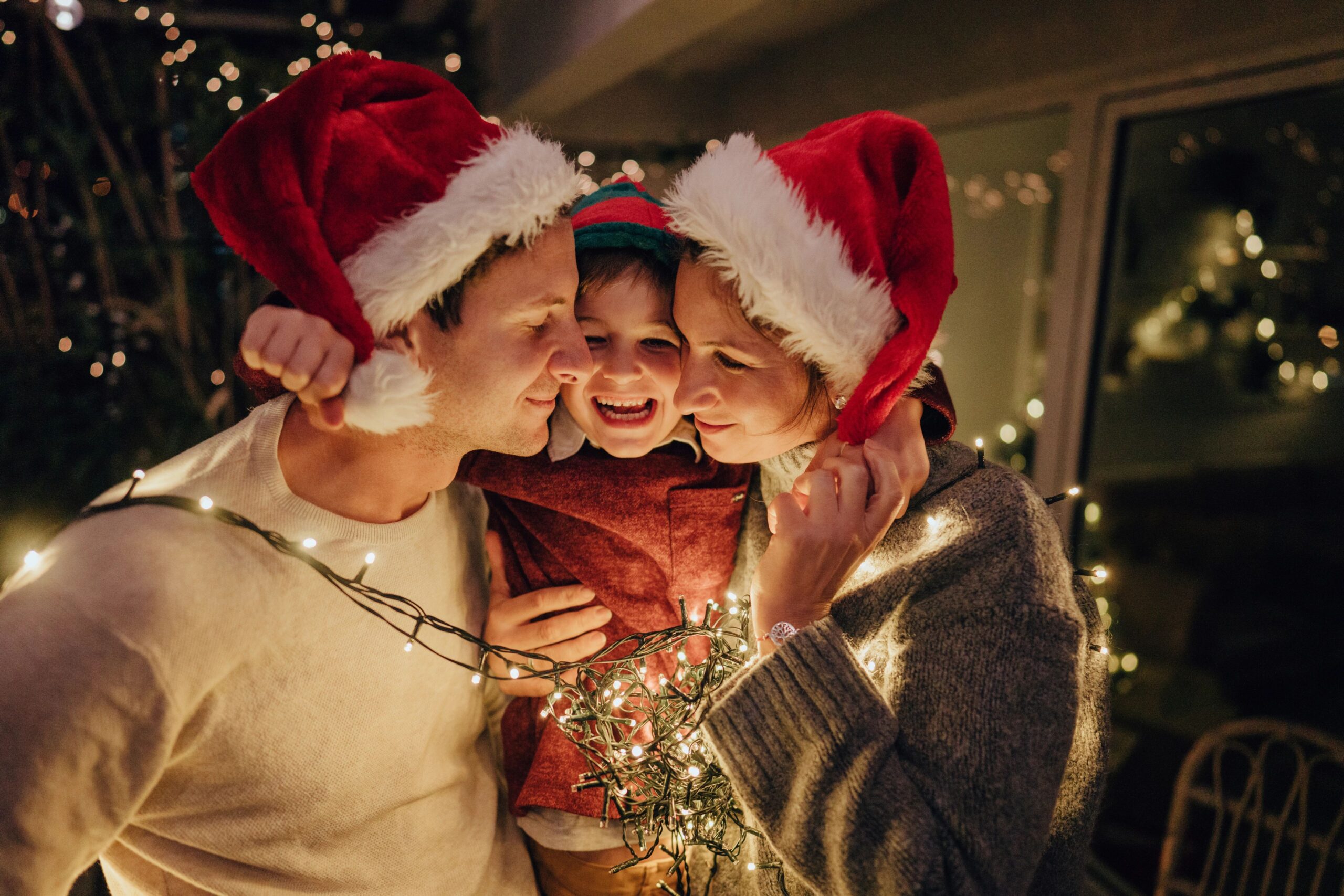 family decorating christmas tree together