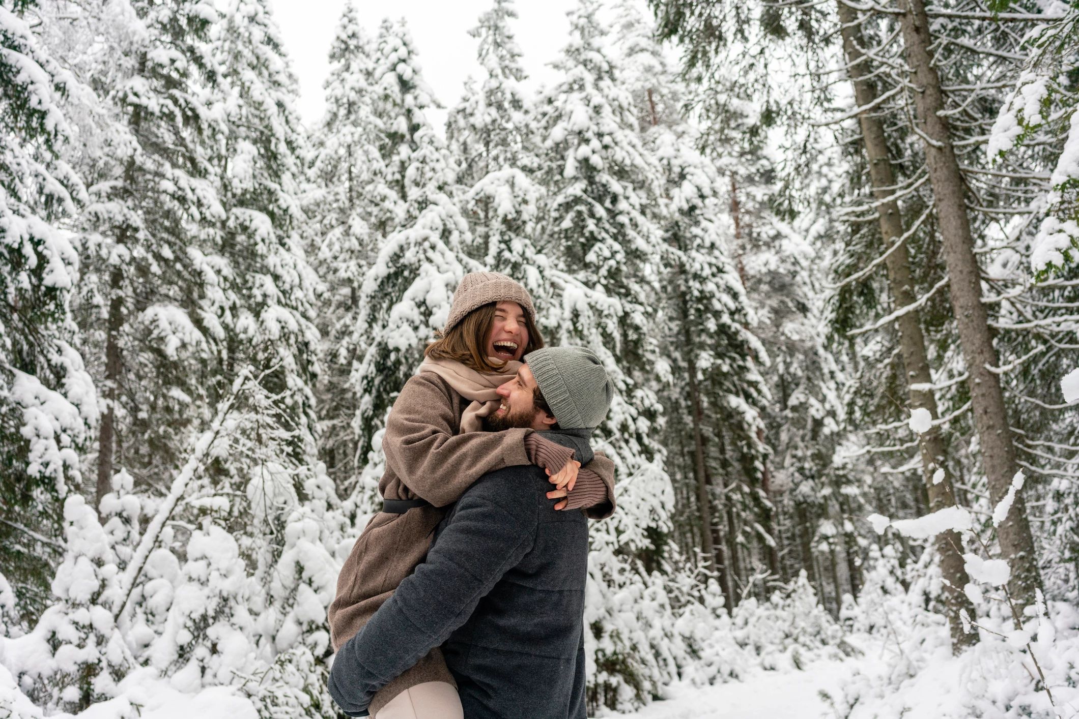 couple posing for christmas photo in snow