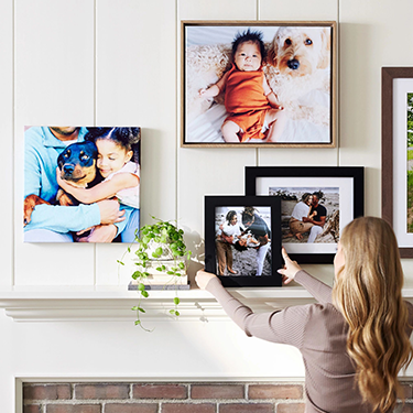 woman putting together a photo gallery wall