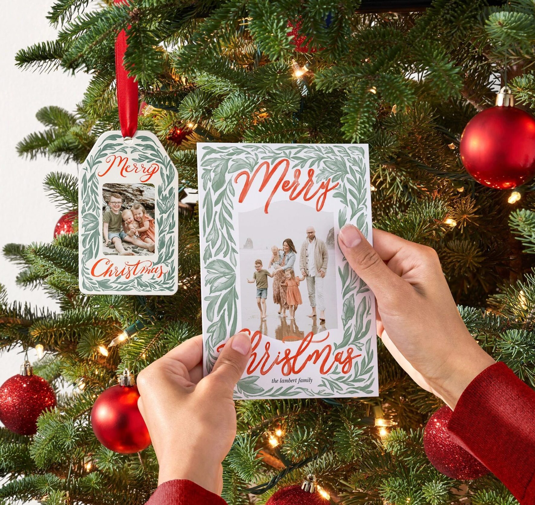 personalized christmas ornament hanging on a tree next to a christmas card