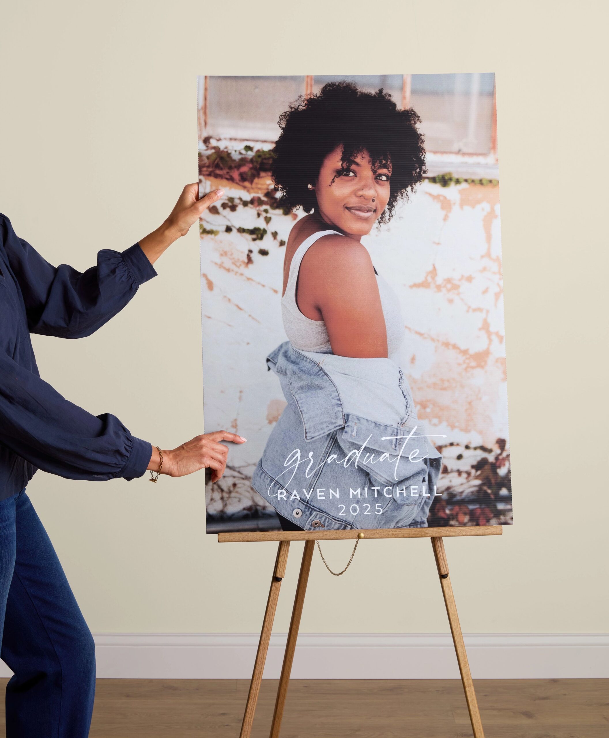 graduation poster board with photo of a young woman graduate