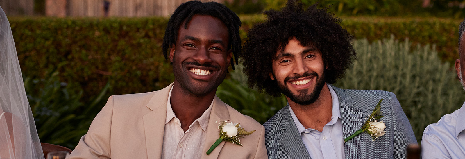 two men at a wedding wearing boutonnieres
