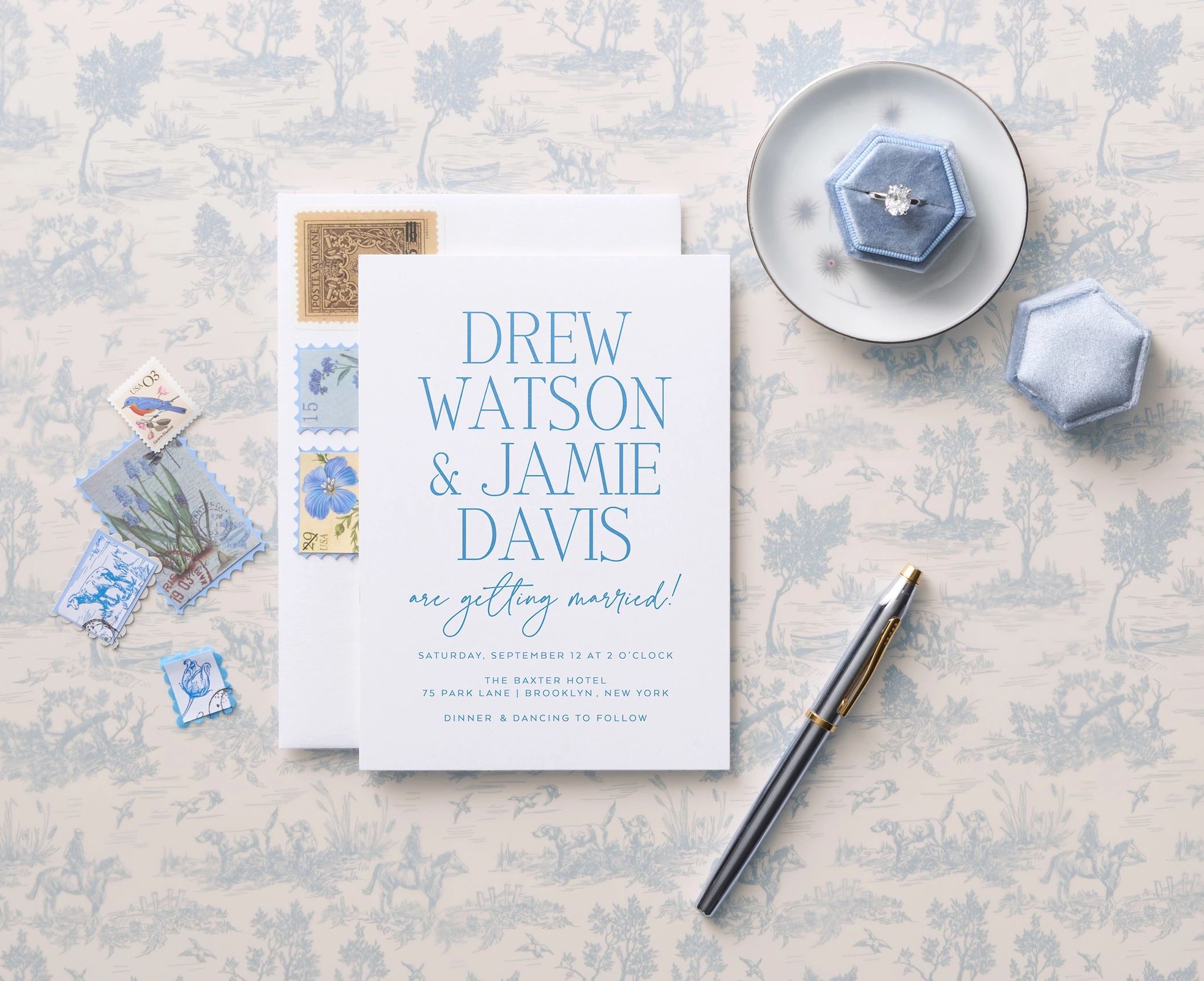 blue and white wedding invitation flatlay