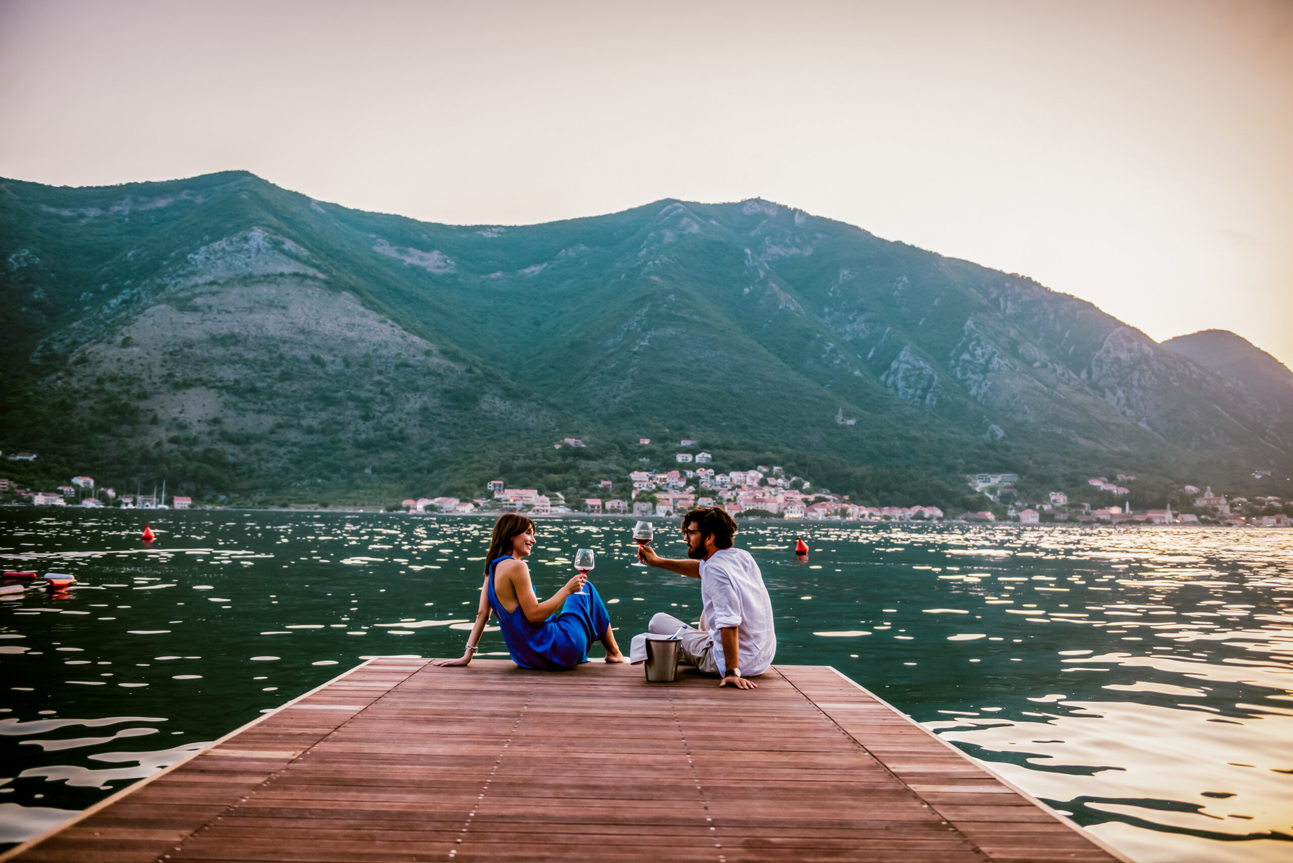 couple drinking wine on a dock