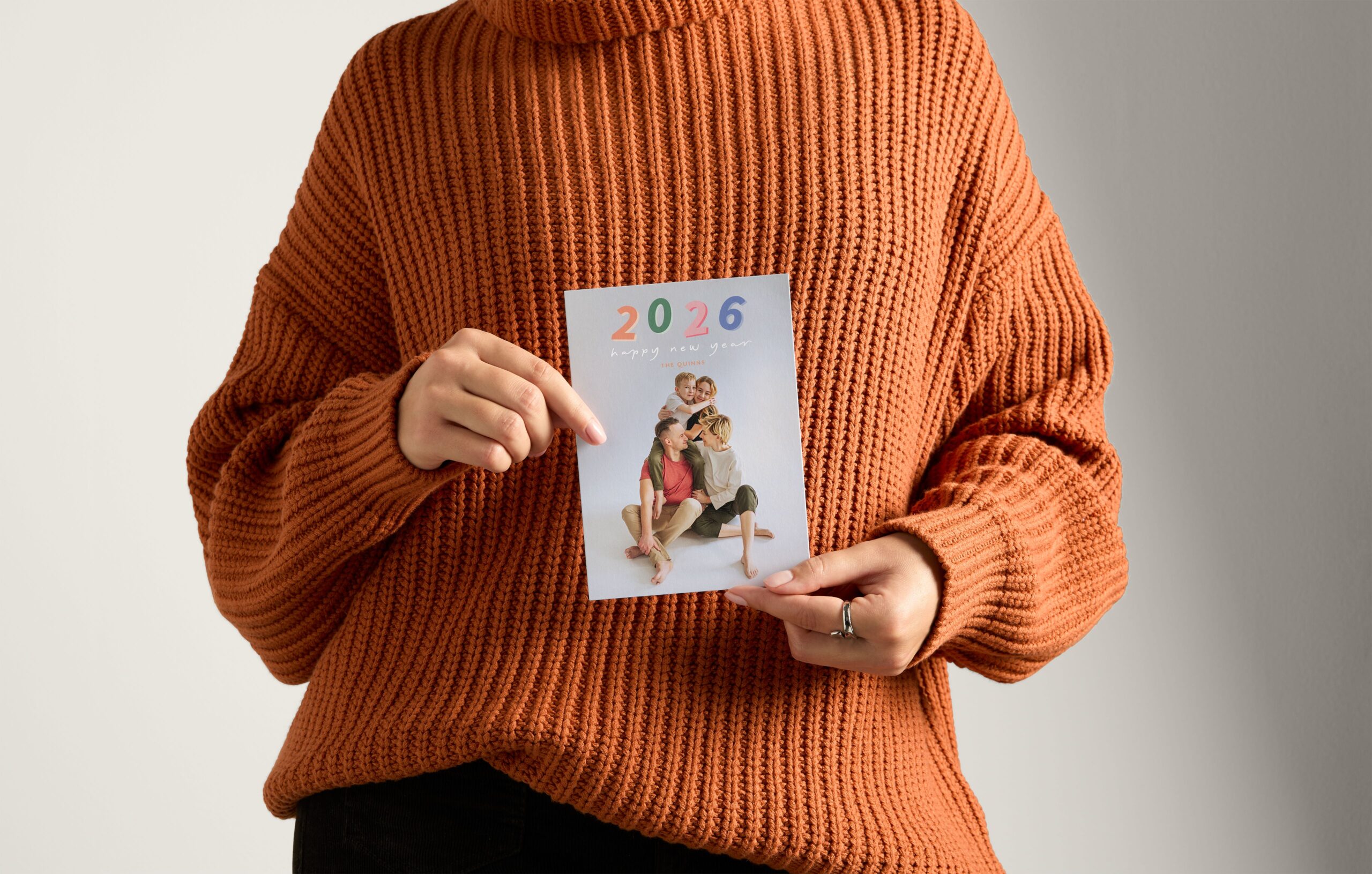 woman holding a new year's card for 2026